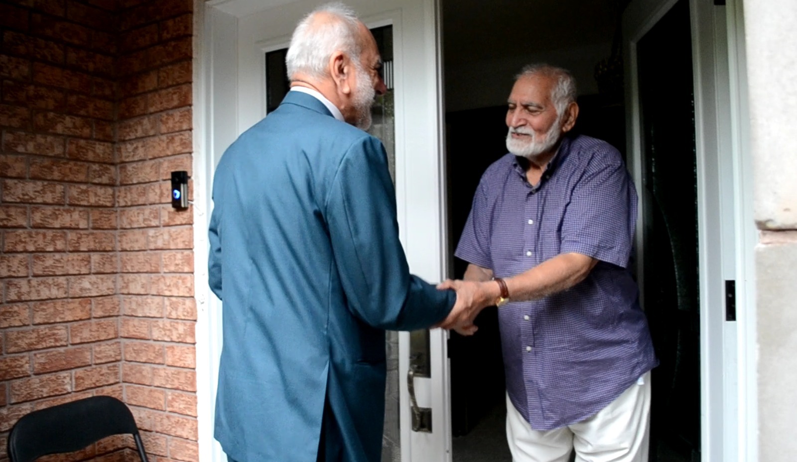 Syed with community member